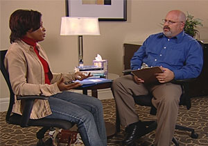 Woman and a man sitting at a table.