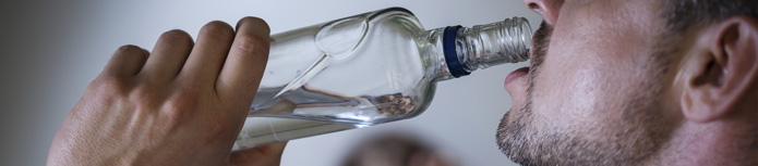 banner: a close shot of a man who drinks a bottle of wine