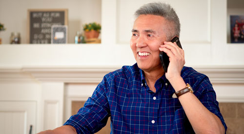 A Veteran on the phone indoors.