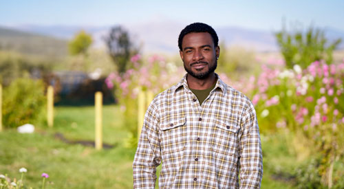 A Veteran standing in a garden.