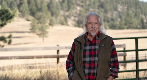 A male Veteran standing outdoors.