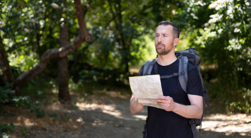 A male Veteran hiking.