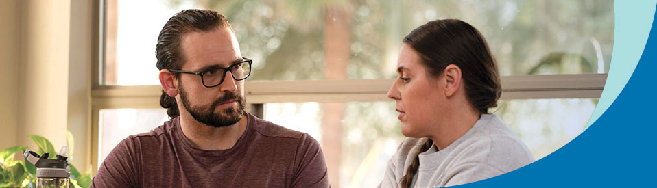 man talking with female veteran