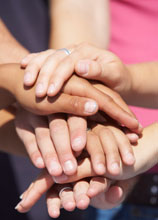Image of hands stacked on top of each other.