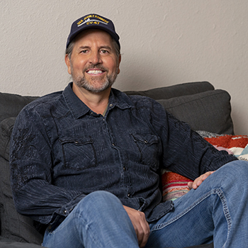 A Veteran sitting on his couch.