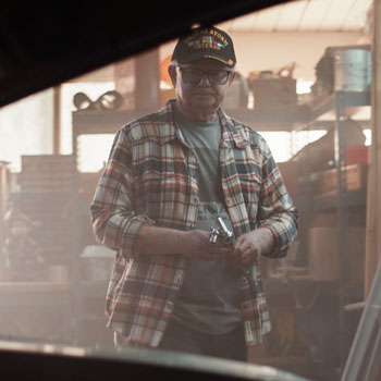 A man wearing a plaid shirt and a 
