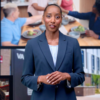 A woman in a navy blazer stands in front of images showing people dining together and a VA residential rehabilitation facility.